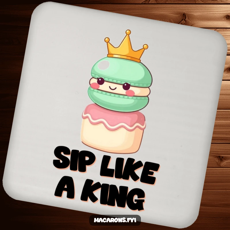 Funny macaron character wearing a small crown, looking regal atop a tiny cake, on a decorative drink coaster.